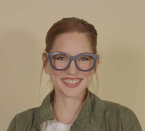 Smiling woman wearing glasses.