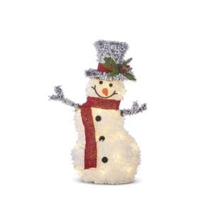 Flocked tinsel snowman built on a metal frame and lit up from within by white twinkle lights. The snowman is formed by three topsy turvy rounds stacked on top of one another. It wears a black tophat with a red band and holly sprig, three black buttons up his body and a knitted red scarf wrapped around its neck. Two stick arms stretch out from its sides.