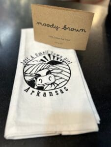 Moody Brown "Just a Small Town Girl" Cow tea towel with the Moody Brown logo wrap