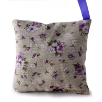 Floral linen sachet with purple ribbon.