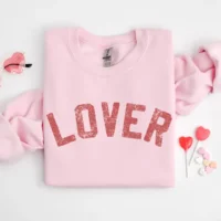 Pink sweatshirt with "Lover" text.