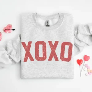 Grey crewneck sweatshirt with XOXO screen-printed in large red font.